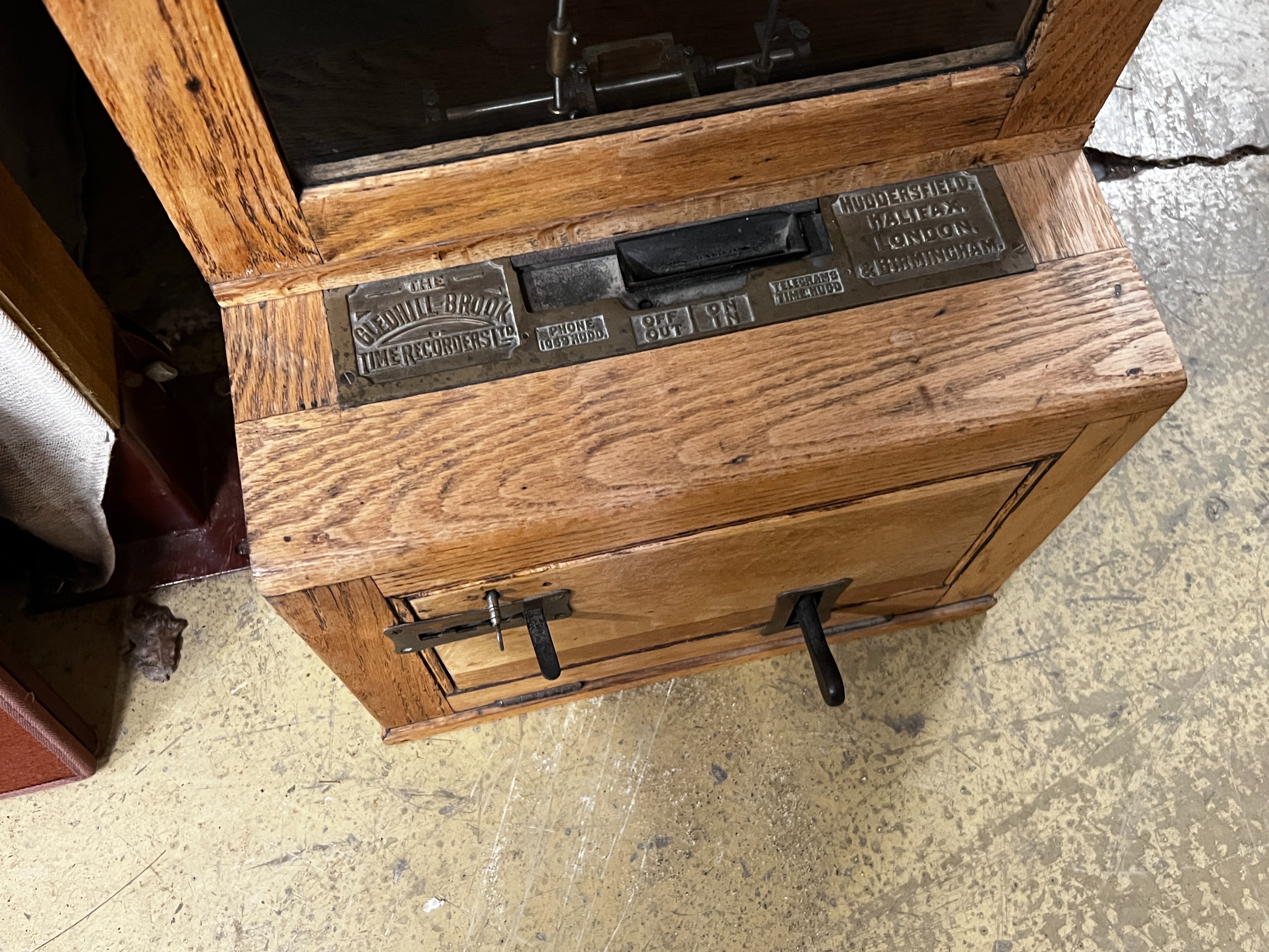 A vintage Gledhill-Brook oak cased clocking in machine, height 106cm